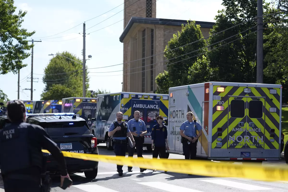 Law enforcement officers gather outside the Annunciation Church and School in response to a reported mass shooting on Wednesday in Minneapolis.