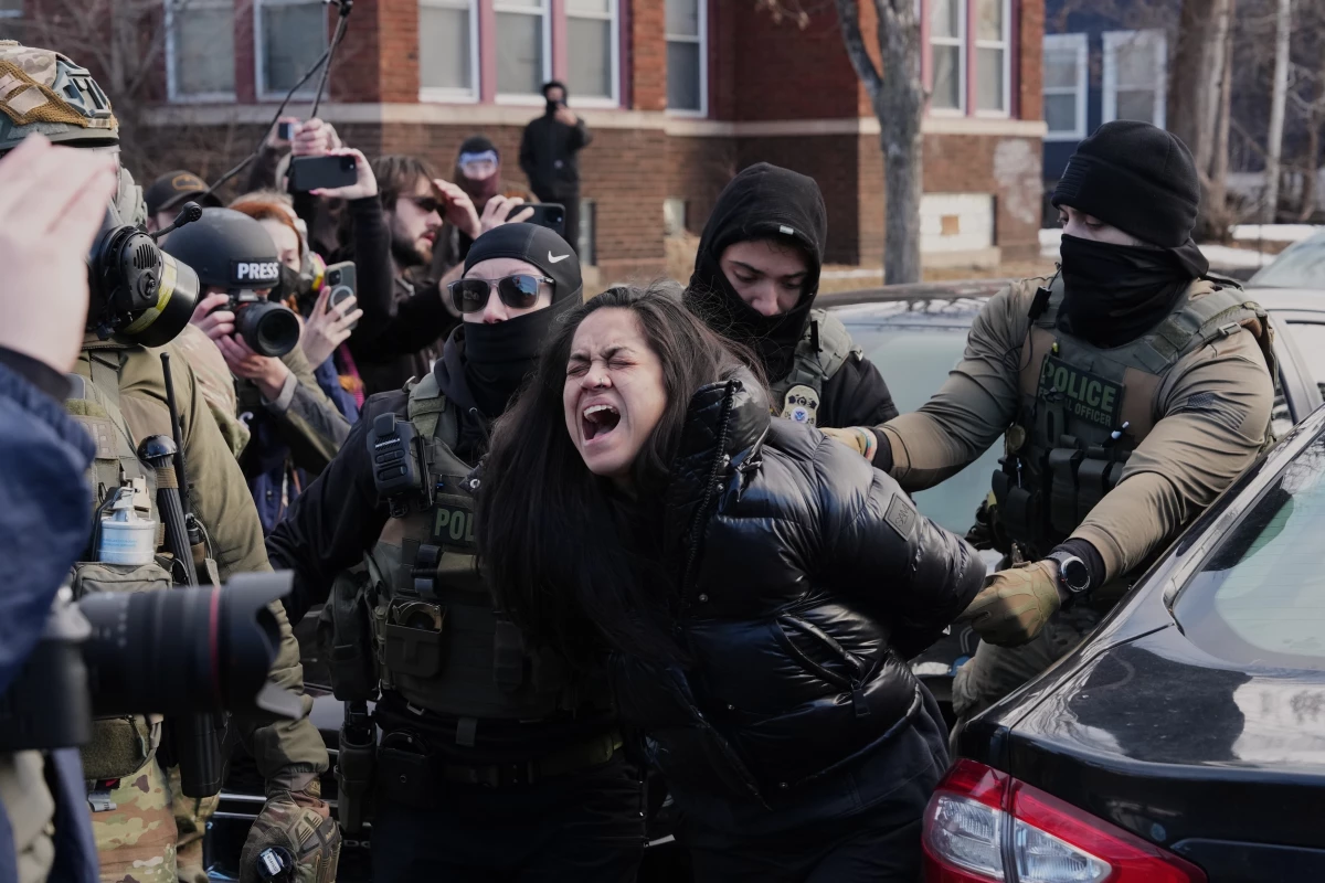 Aliya Rahman is detained by federal agents near the scene where Renee Macklin Good was fatally shot by an ICE officer last week, Jan. 13, 2026, in Minneapolis.