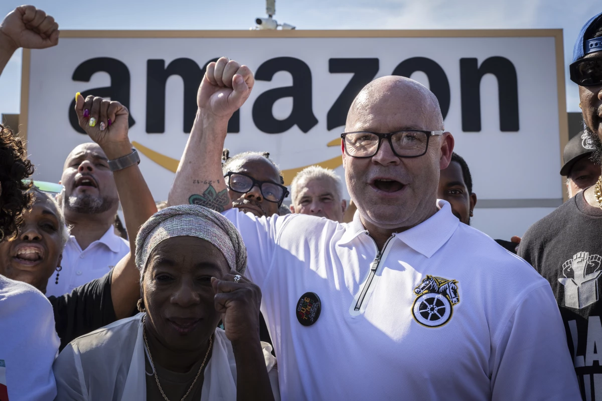Teamsters General President Sean M. O'Brien, center, is shown rallying with Amazon workers outside the Staten Island Amazon facility JFK8, June 19, 2024, in New York.