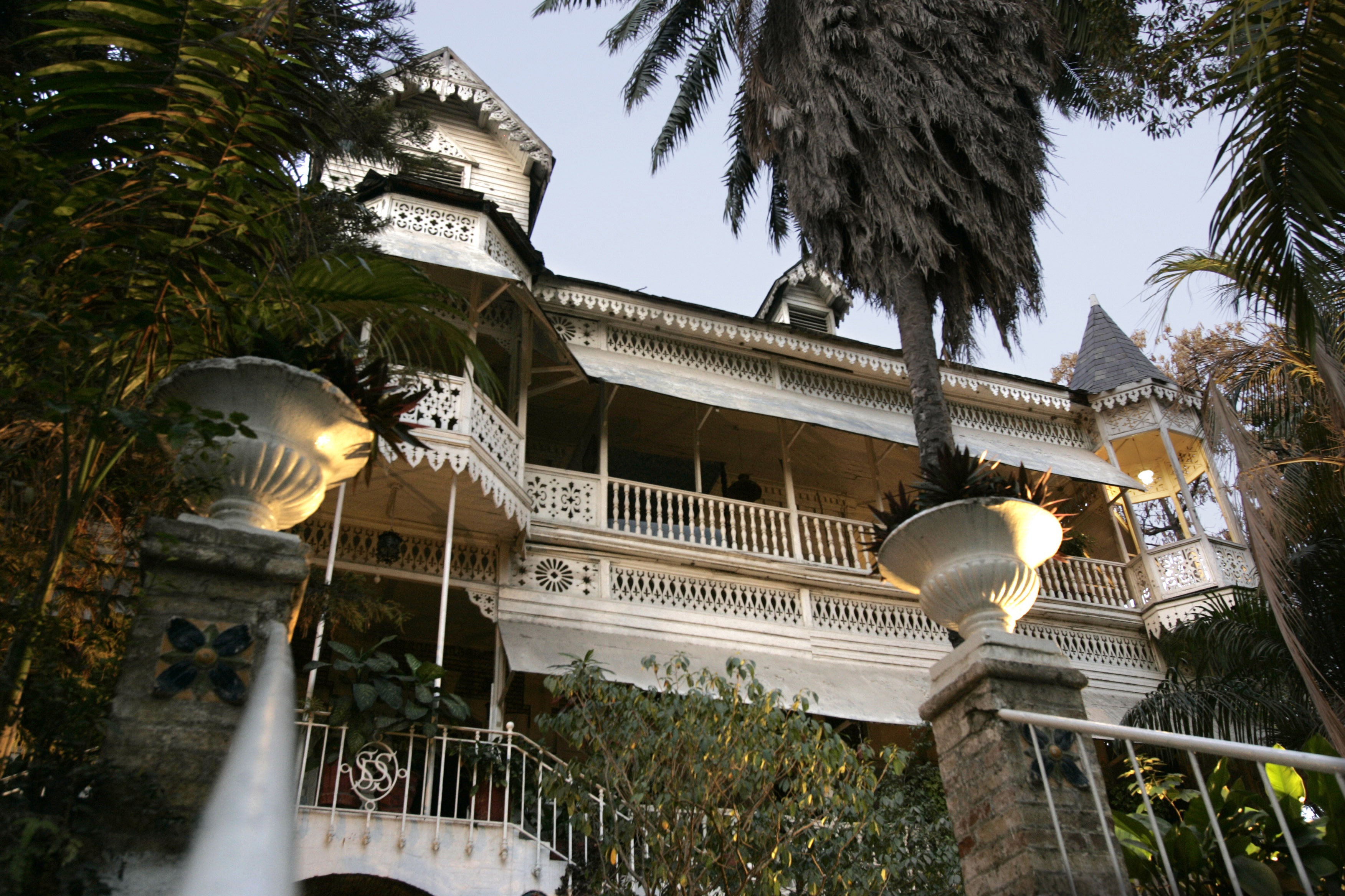 Main entry to the Hotel Oloffson, built as a private residence by Simon Sam in about 1886. U.S. Marines leased it and turned it into a military hospital in the early 20th century. In 1936, Walter Oloffson converted it to a hotel. In the 1950s through the 1970s, it was a Hollywood jet set destination. (Getty Images)