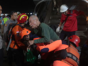 Rescuers assist a survivors of a ferry fire upon arrival at Tanjung Perak Port in Surabaya, East Java, Indonesia, Monday, Aug. 3, 2026.