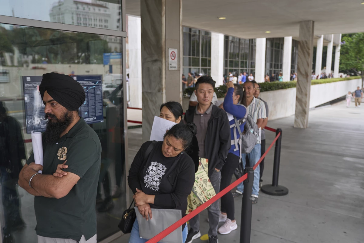 In June 2025, people line up outside the Los Angeles Federal Building, which houses offices for U.S. Immigration and Customs Enforcement and U.S. Citizenship and Immigration Services.