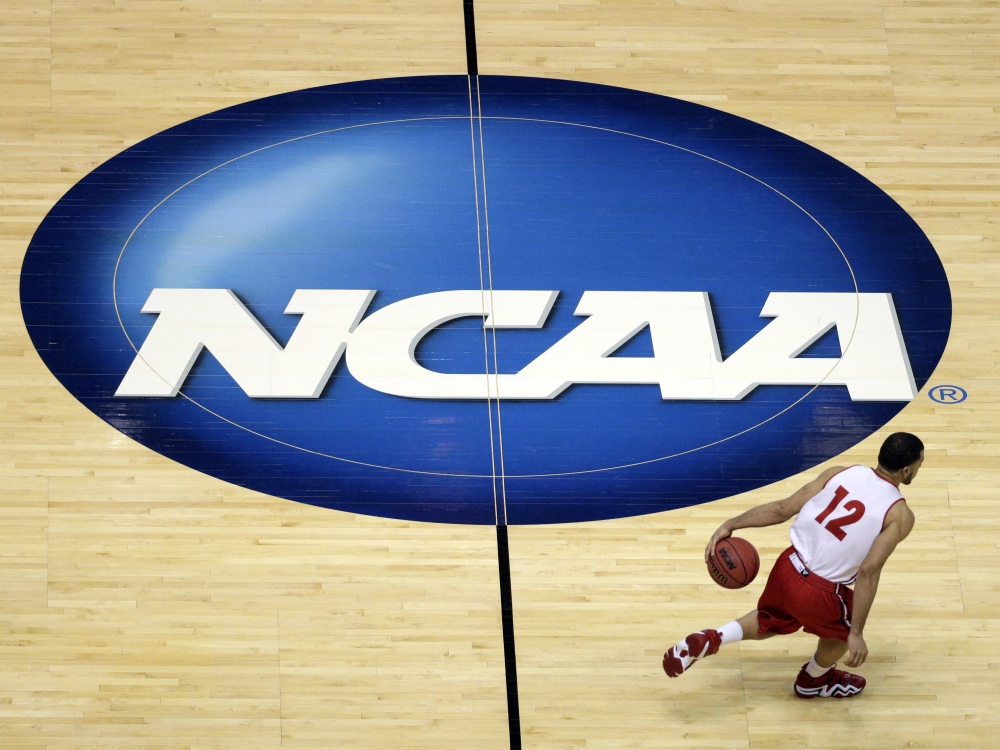 FILE - Wisconsin's Traevon Jackson dribbles past the NCAA logo during practice at the NCAA men's college basketball tournament March 26, 2014, in Anaheim, Calif. (AP)