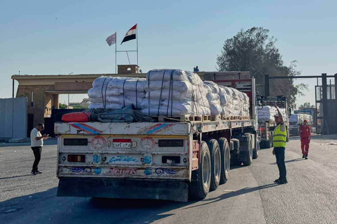 Trucks carrying humanitarian aids enter the Rafah crossing between Egypt and the Gaza Strip, Sunday, July 27, 2025.