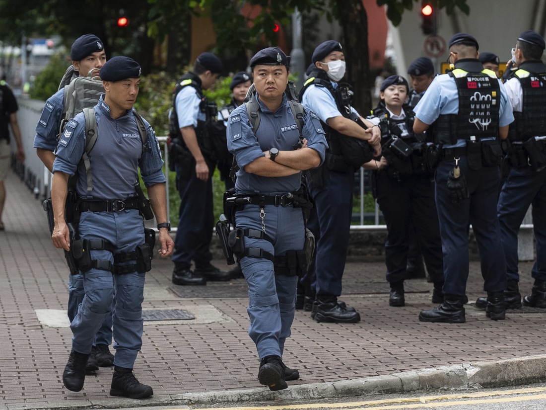 Police officers stand guard outside the West Kowloon Magistrates' Courts in Hong Kong, Thursday, May 30, 2024. The Hong Kong court on Thursday convicted 14 pro-democracy activists in the city’s biggest national security case under a law imposed by Beijing that has all but wiped out public dissent. (AP Photo/Chan Long Hei)