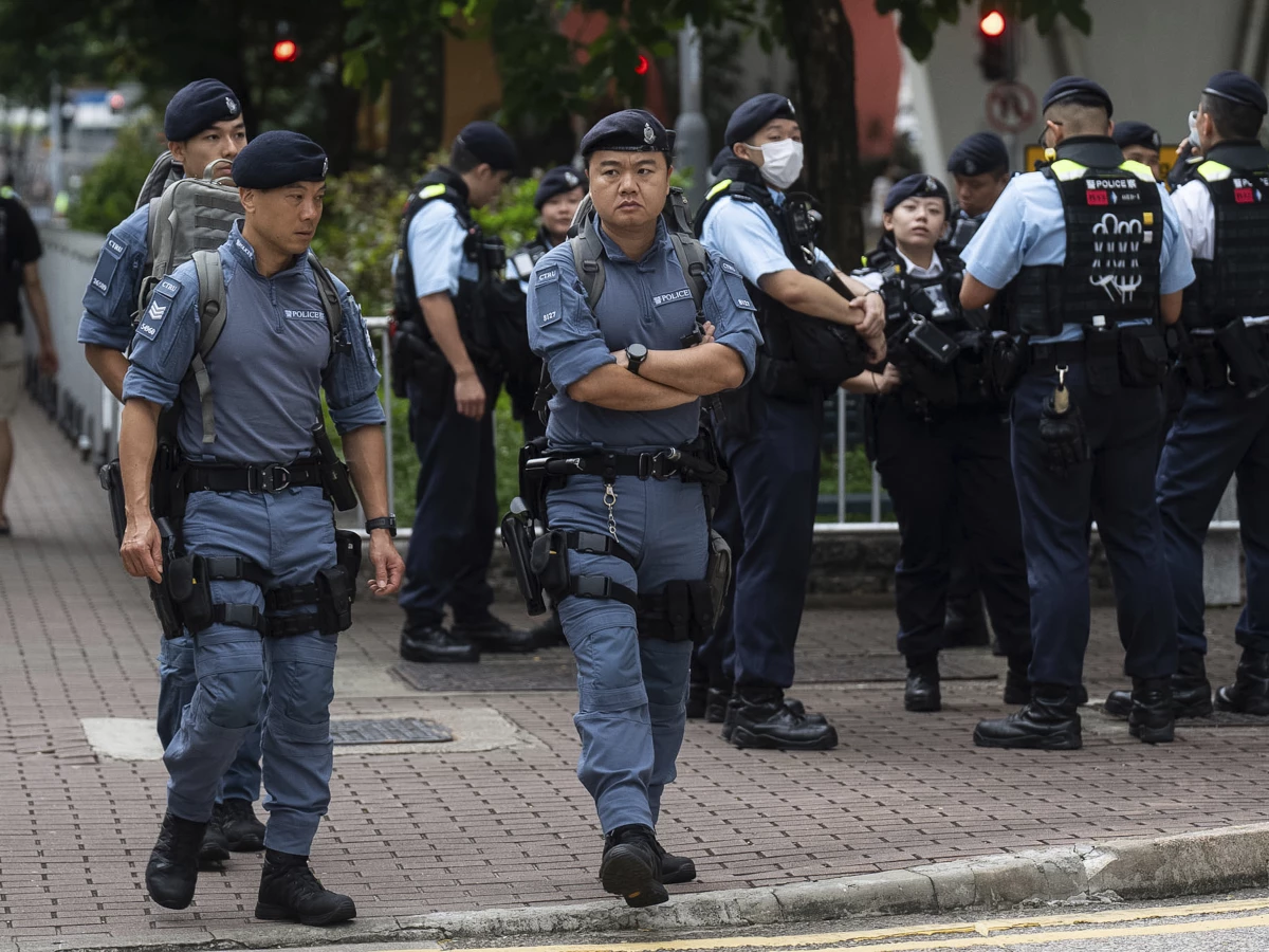 Police officers stand guard outside the West Kowloon Magistrates' Courts in Hong Kong on Thursday.