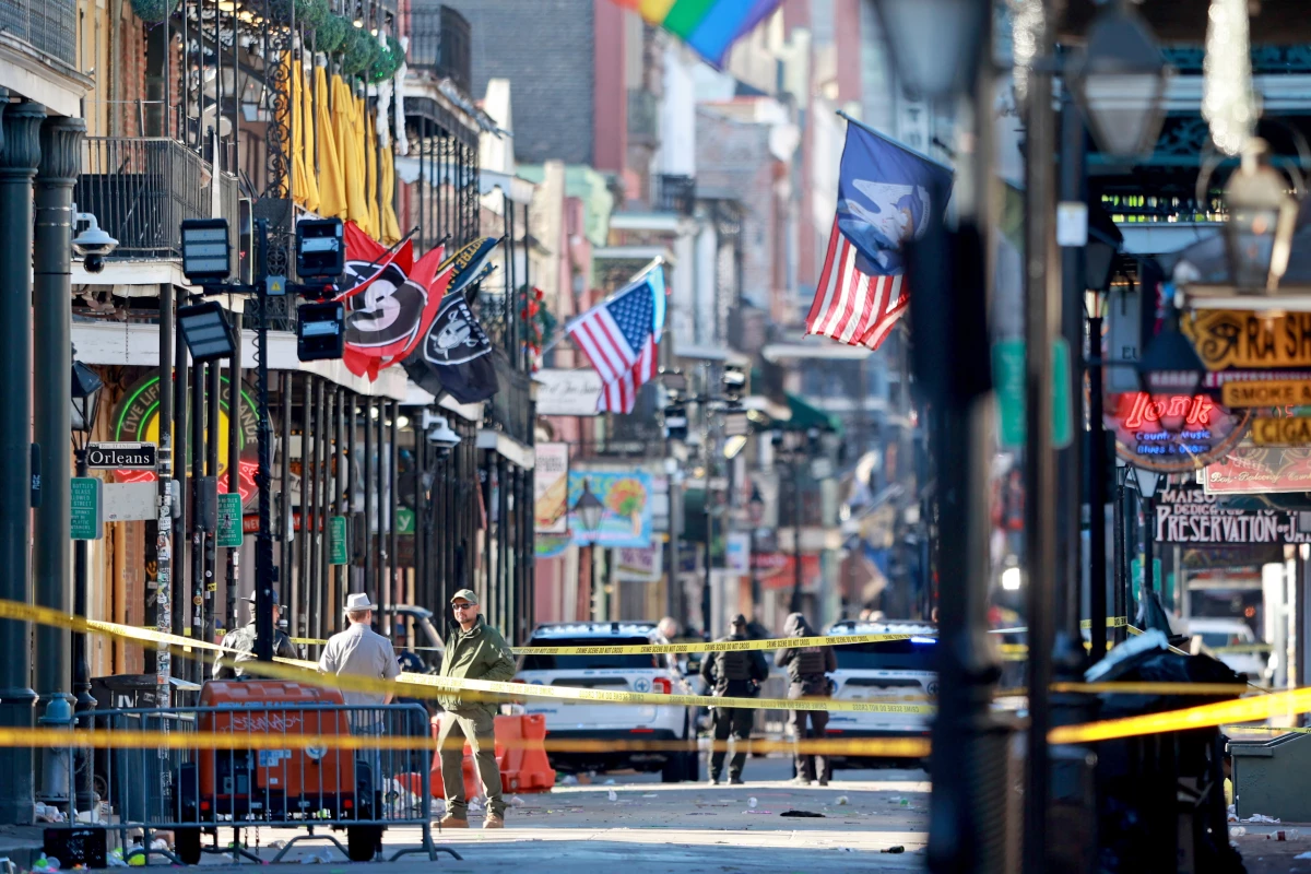 Law enforcement officers from multiple agencies work the scene on Bourbon Street after at least ten people were killed when a person allegedly drove into the crowd in the early morning hours of New Year's Day.