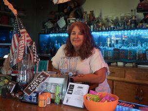 Vickie O'Haro stands behind the bar at Atomic City Bar & Store, which she owns, along with Atomic Motor Raceway, on June 8, 2026. The businesses are located near Idaho National Laboratory.