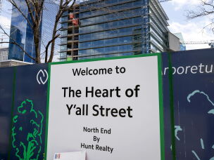 Signage along the construction fence outside the new Goldman Sachs campus in Dallas. The bank and its rivals are seeing more incentives to hire more senior, high-profile bankers in Dallas: They'll be closer to lucrative potential clients, as more big companies and wealthy individuals move to the Lone Star State.