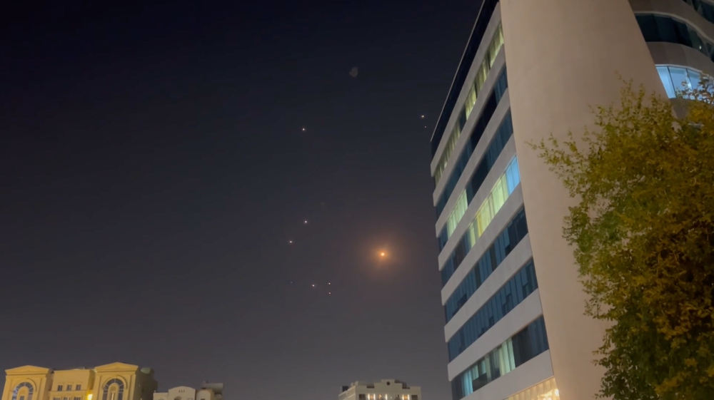 In this screenshot from a video, missiles and air defense interceptors illuminate the night sky over Doha after Iran launched an attack on U.S. forces at Al Udeid Air Base in Qatar on Monday.