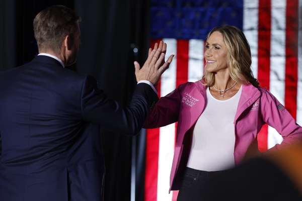Eric Trump and his wife, Republican National Committee Co-Chair Lara Trump high-five during a rally for former President Donald Trump in Reading, Pa., on Monday.