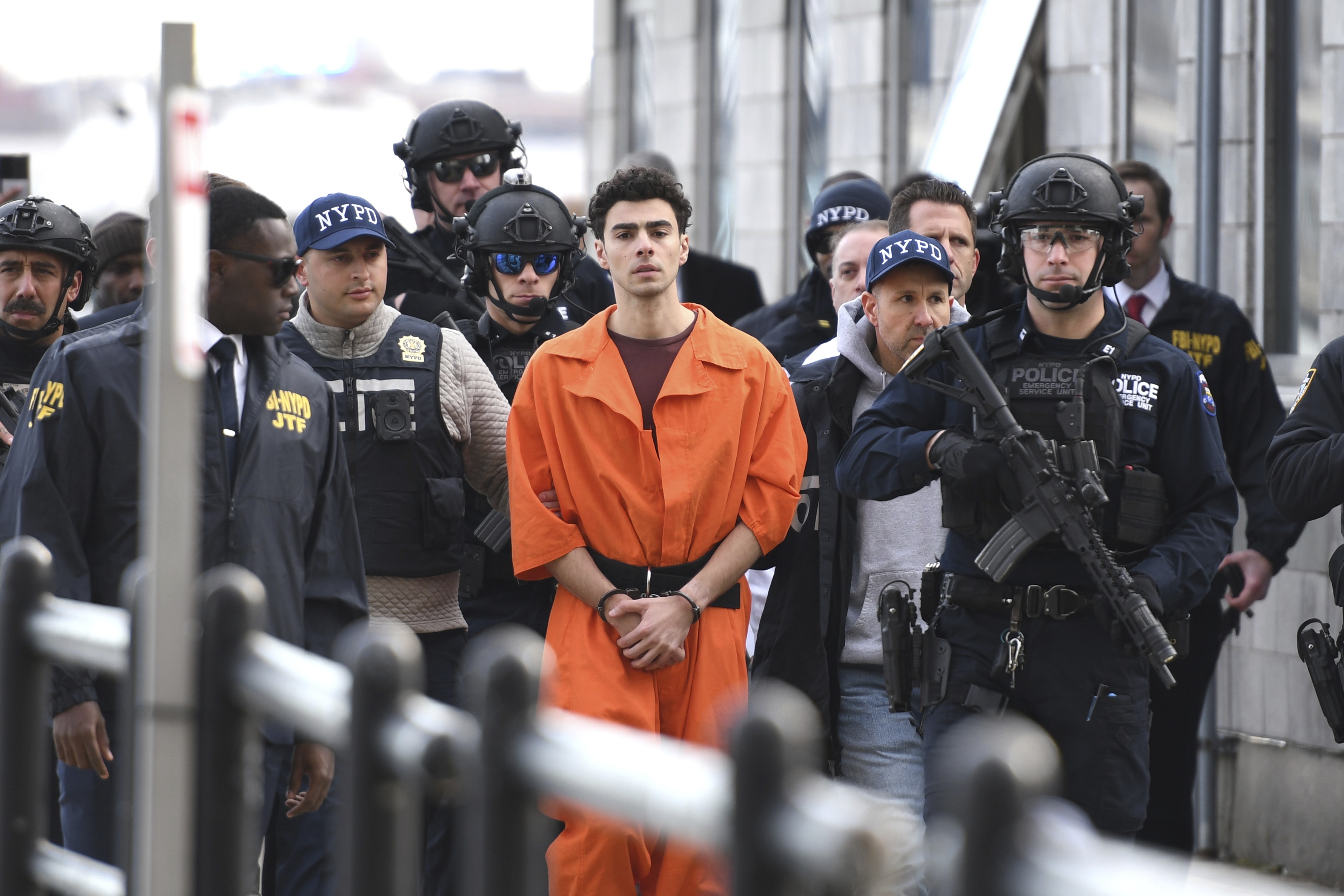 Luigi Mangione, a suspect in the killing of UnitedHealthcare CEO Brian Thompson, is escorted by police from an NYPD helicopter on Thursday, in New York, where he faces four counts of federal charges including murder. (AP)