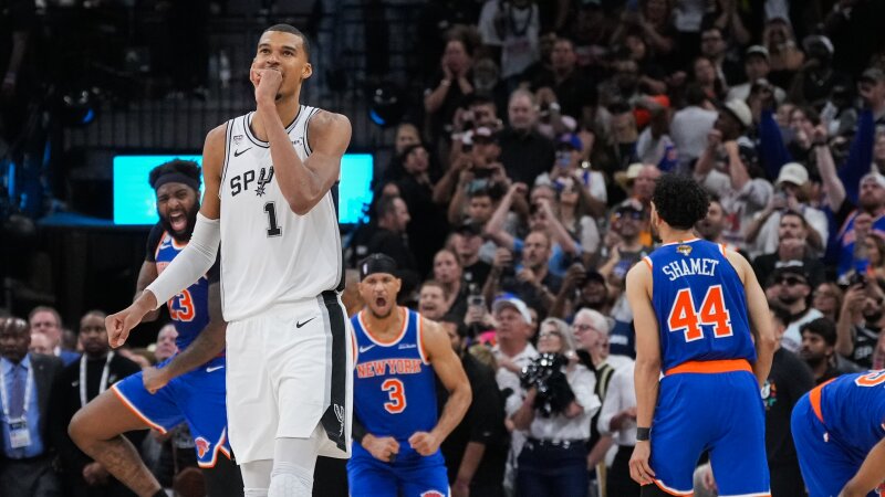 San Antonio Spurs forward Victor Wembanyama walks off the court as time expires during the second half of Game 2 of the NBA Finals basketball series as New York Knicks guard Landry Shamet (44), guard Josh Hart (3), and center Mitchell Robinson (23) celebrate, Friday, June 5, 2026, in San Antonio.
