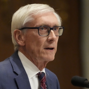 Wisconsin Gov. Tony Evers speaks at the state Capitol in Madison in early 2025. Evers, who won't seek another term in office, is seeking a constitutional amendment that would ban partisan gerrymandering in the state.
