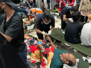 In this photo taken with a smartphone, survivors receive medical treatment after a ferry sank in bad weather in the Java Sea, at a port in Banjarmasin, South Kalimantan, Indonesia, Sunday, Sept. 13, 2026.