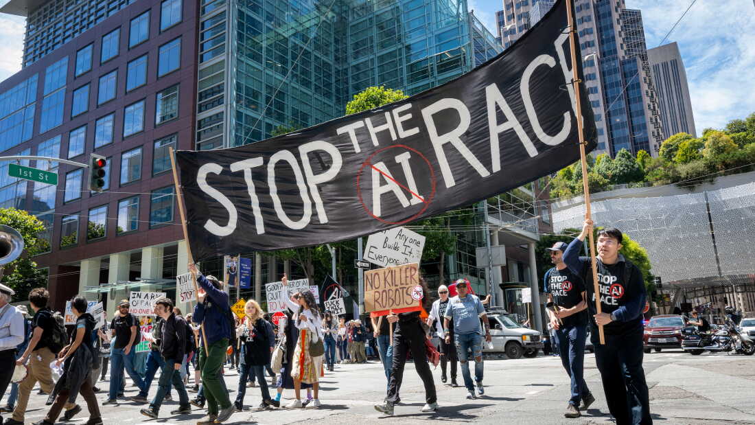 Demonstrators participate in the "Stop the AI Race" protest march in San Francisco, California, on July 11, 2026. Researchers who spoke to NPR say that the leading AI companies are too focused on racing to develop more capable and autonomous AI systems while safety is falling behind