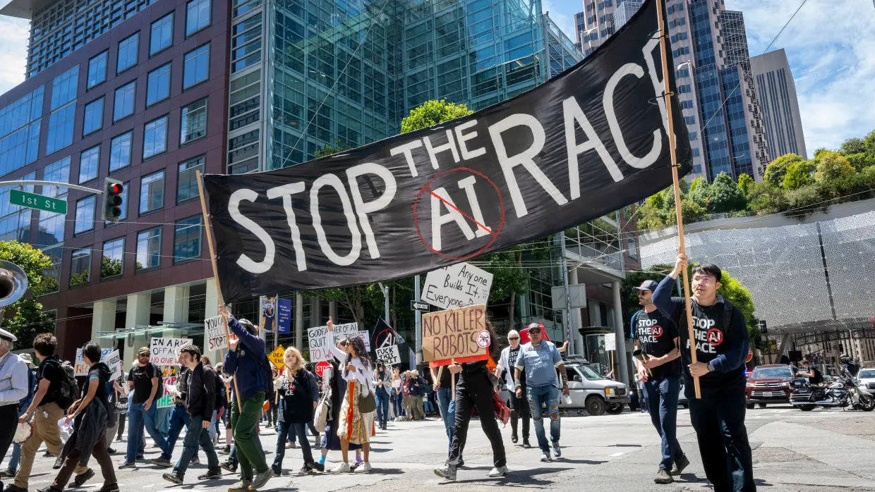 Demonstrators participate in the "Stop the AI Race" protest march in San Francisco on July 11, 2026. Researchers who spoke to NPR say the leading AI companies are too focused on racing to develop more capable and autonomous AI systems while safety is falling behind.