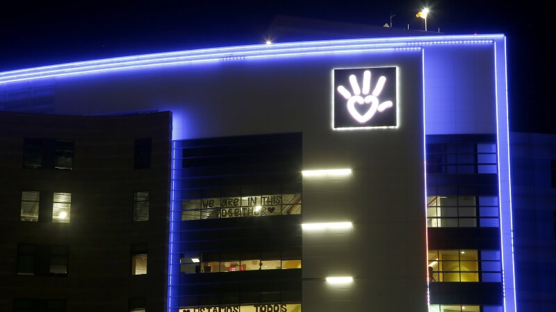 Phoenix Children's Hospital is shown at night with blue light outlining it.