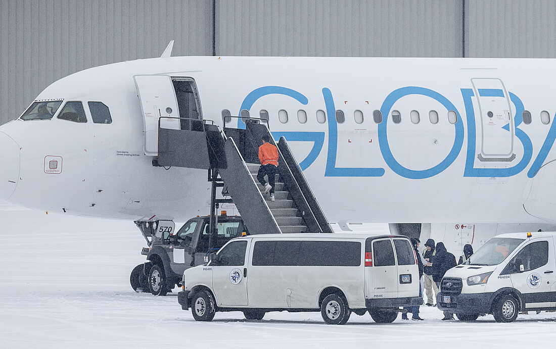 A detainee boards a deportation flight on GlobalX Air in Minnesota in December 2025.