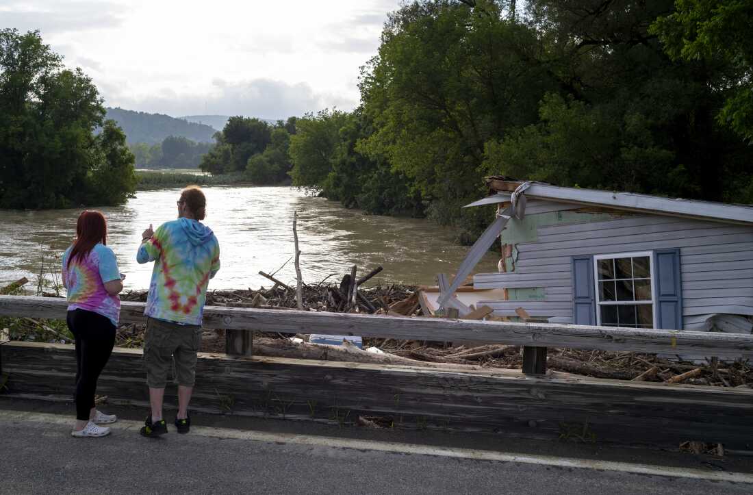 A mobile home swept from its foundation is seen lodged about 1,000 feet away from the property where it stood near a bridge on the Canisteo River, Friday, in Canisteo, N.Y., after remnants of Tropical Storm Debby swept through the area.