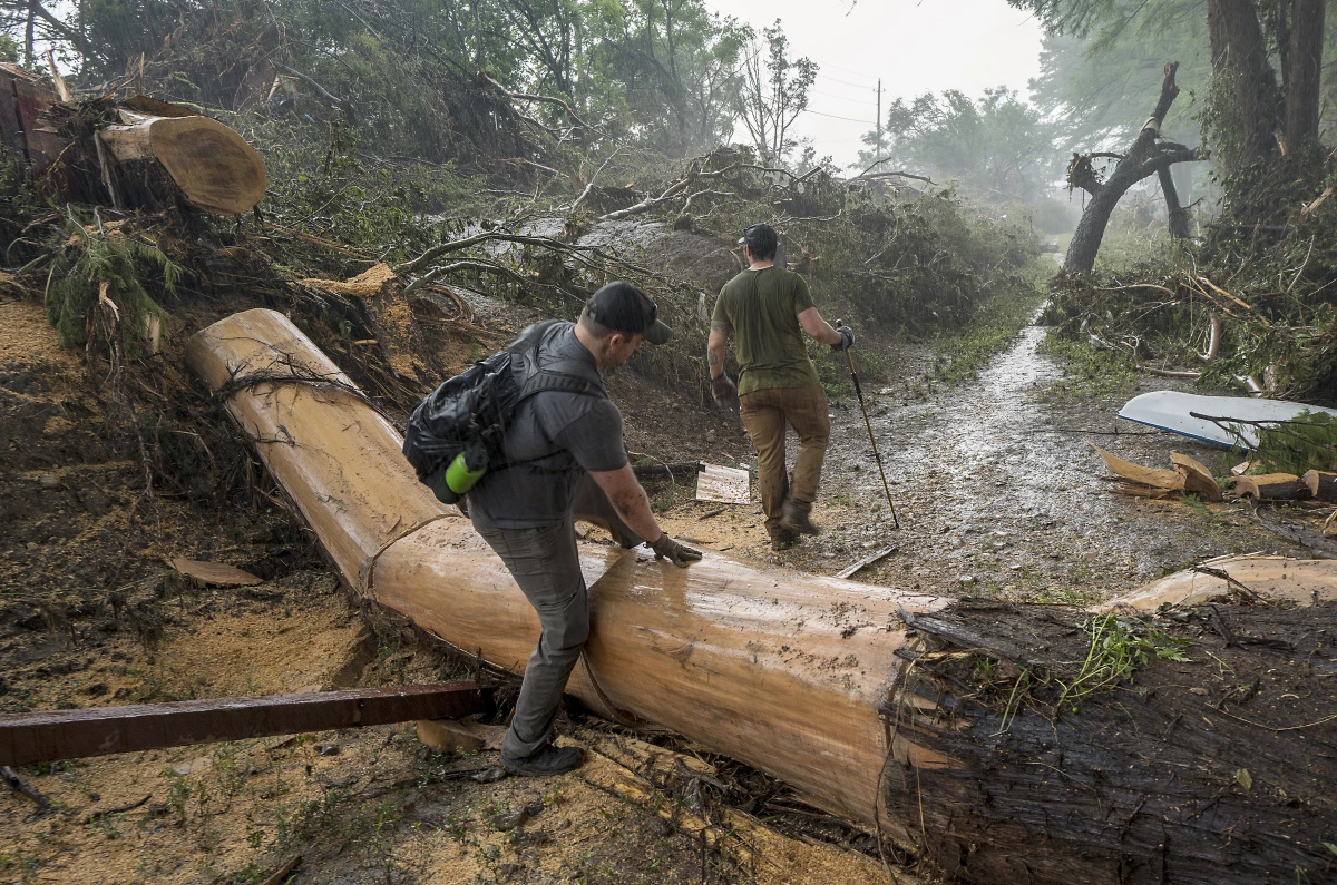 Volunteers search for missing people along the banks of the Guadalupe River after recent flooding in Hunt, Texas.