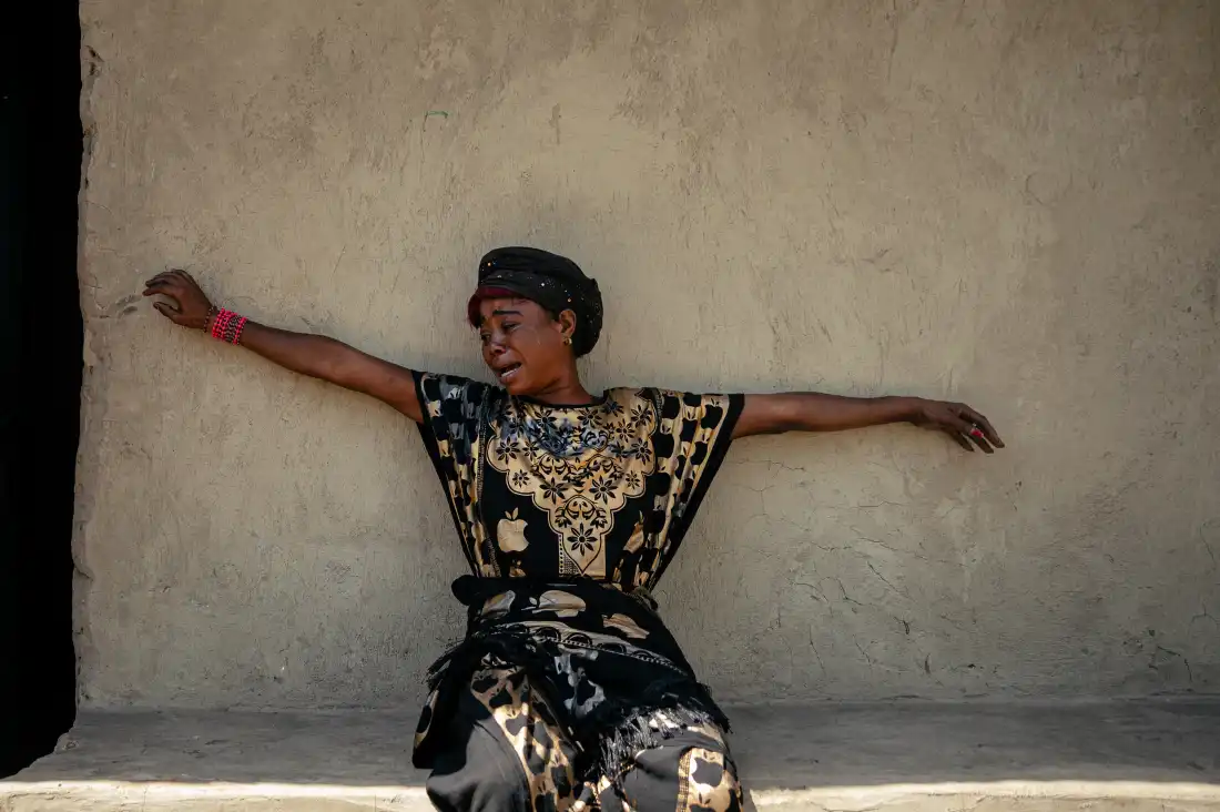 A woman mourns the loss of a relative suspected of having died from Ebola.