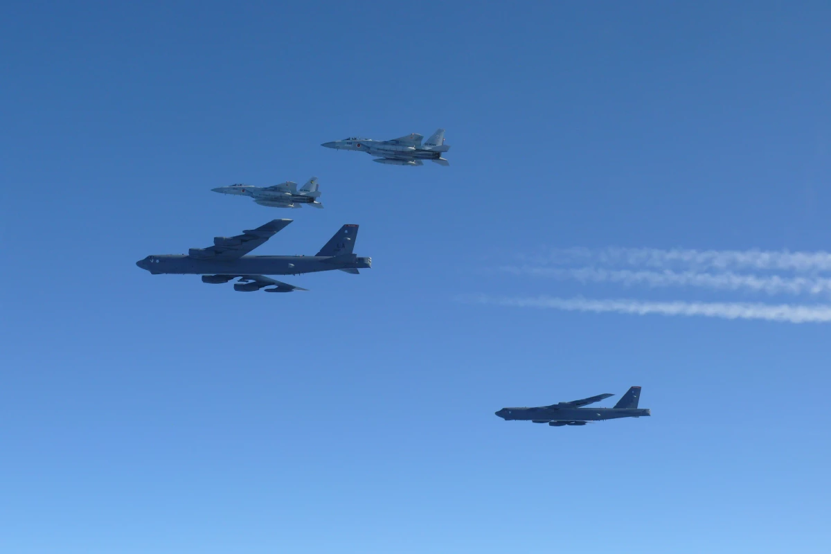 This photo provided by Japan's Ministry of Defense shows the Japan Air Self-Defense Force's F-15 fighters holding a joint military drill with U.S. B-52 bombers in the vicinity of Japanese airspace on Wednesday.