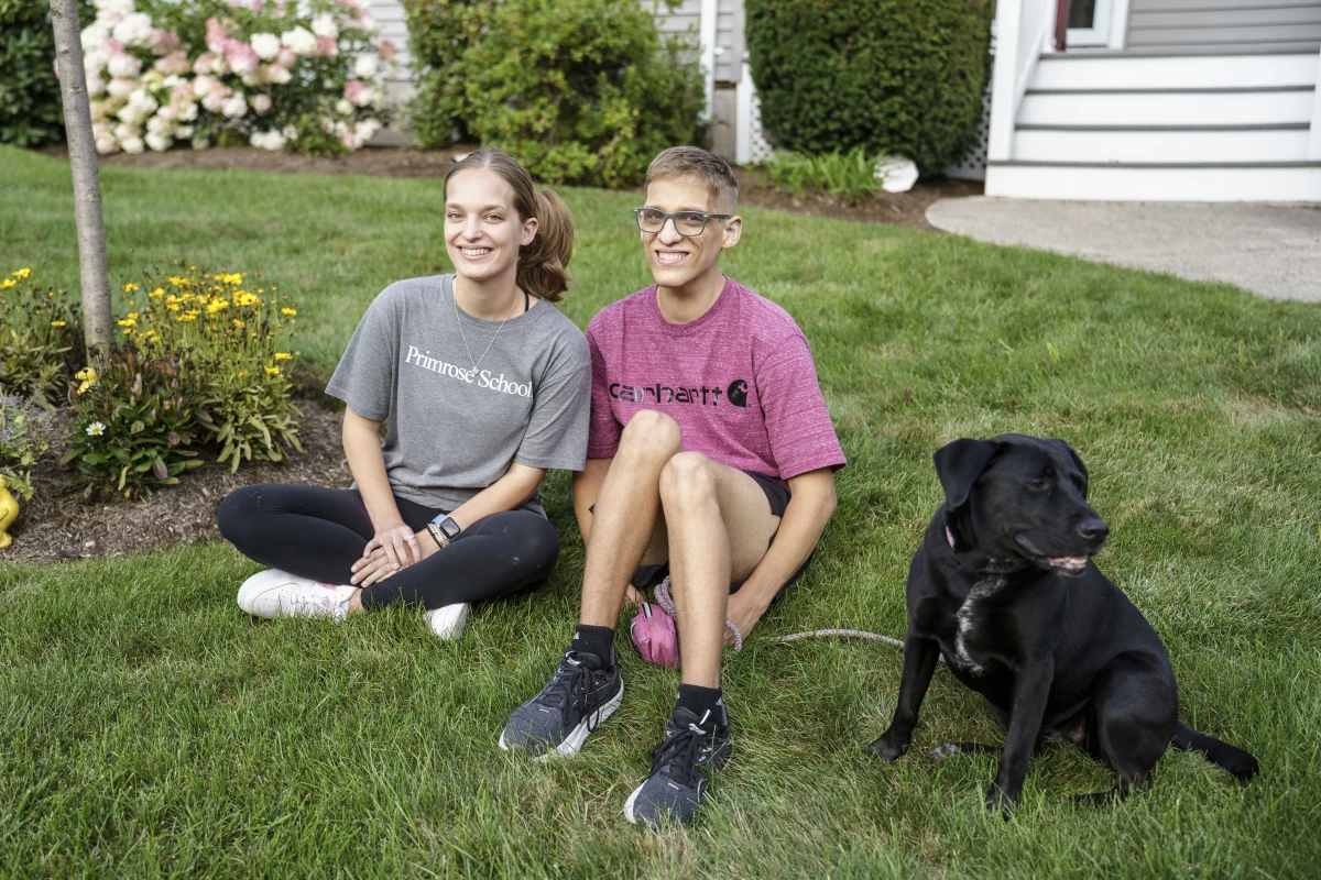 August 22, 2024, Natick, MA.  Jason Mazzola at home with his twin sister Jessica and dog Marley.