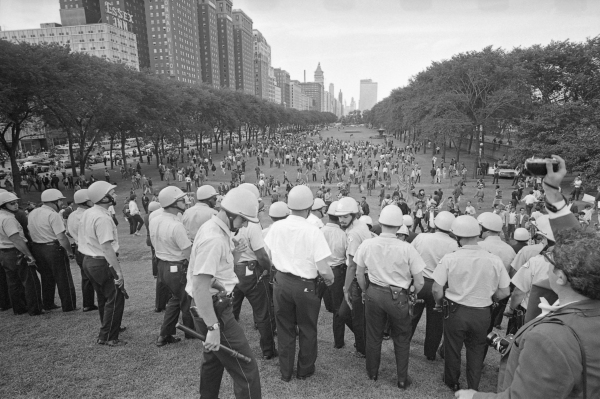 General view of police lined up and holding batons in Grant Park trying to control the crowd with protesters during the 1968 Democratic National Convention in Chicago, Illinois, August 1968.