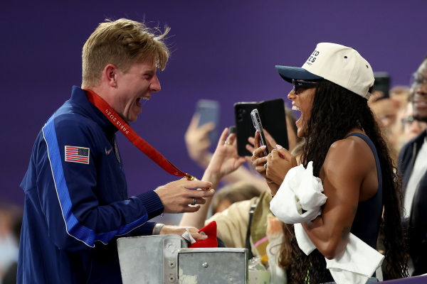 Gold medalist Hunter Woodhall of Team United States celebrates with wife and fellow Olympian Tara Davis-Woodhall during the Men's 400m T62 medal ceremony on Friday.