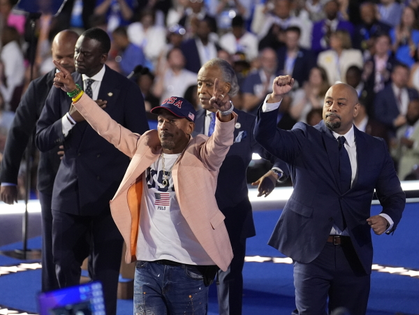 The Central Park Five join Reverend Al Sharpton during the Democratic National Convention last month, in Chicago. (AP Photo/Charles Rex Arbogast)