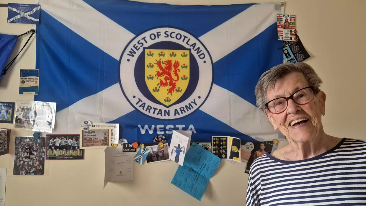 Moira Brown, 93, at her home in Glasgow, where the walls are plastered with Scotland soccer memorabilia.