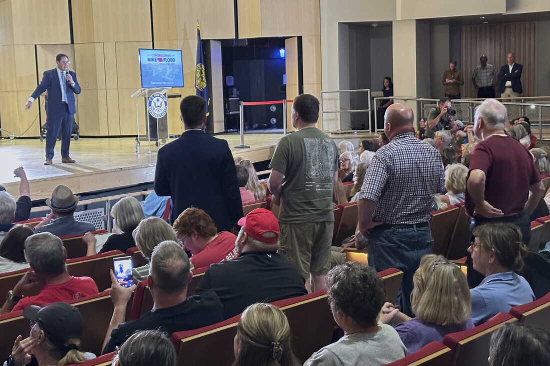 Rep. Mike Flood speaks and takes questions during a town hall meeting on the University of Nebraska campus, Monday, August 4, 2025 in Lincoln, Neb. The second-term Republican braved a Democratic-heavy audience of roughly 700, most of whom booed and chanted in opposition to the GOP-backed tax-break and spending-cut bill President Donald Trump signed last month. (AP Photo/Thomas Beaumont)