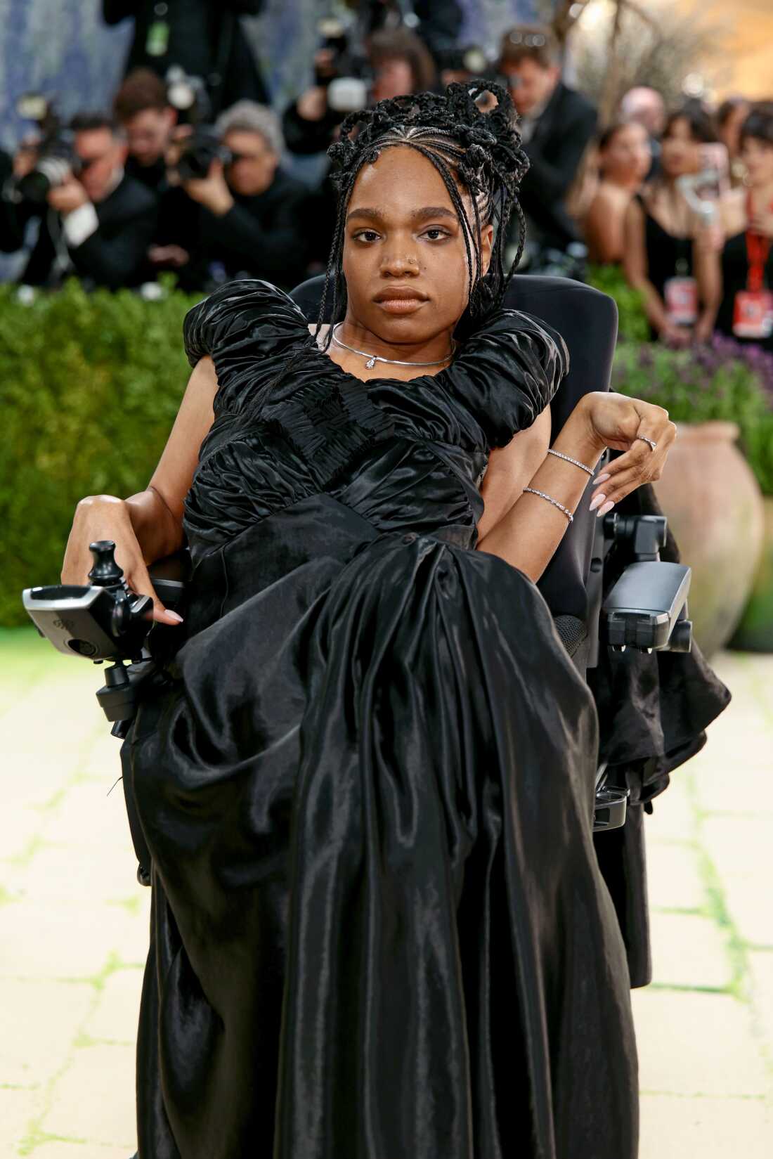 Model Aariana Rose Philip attends the 2026 Met Gala. She is wearing a black ruched gown and she uses a motorized wheelchair.