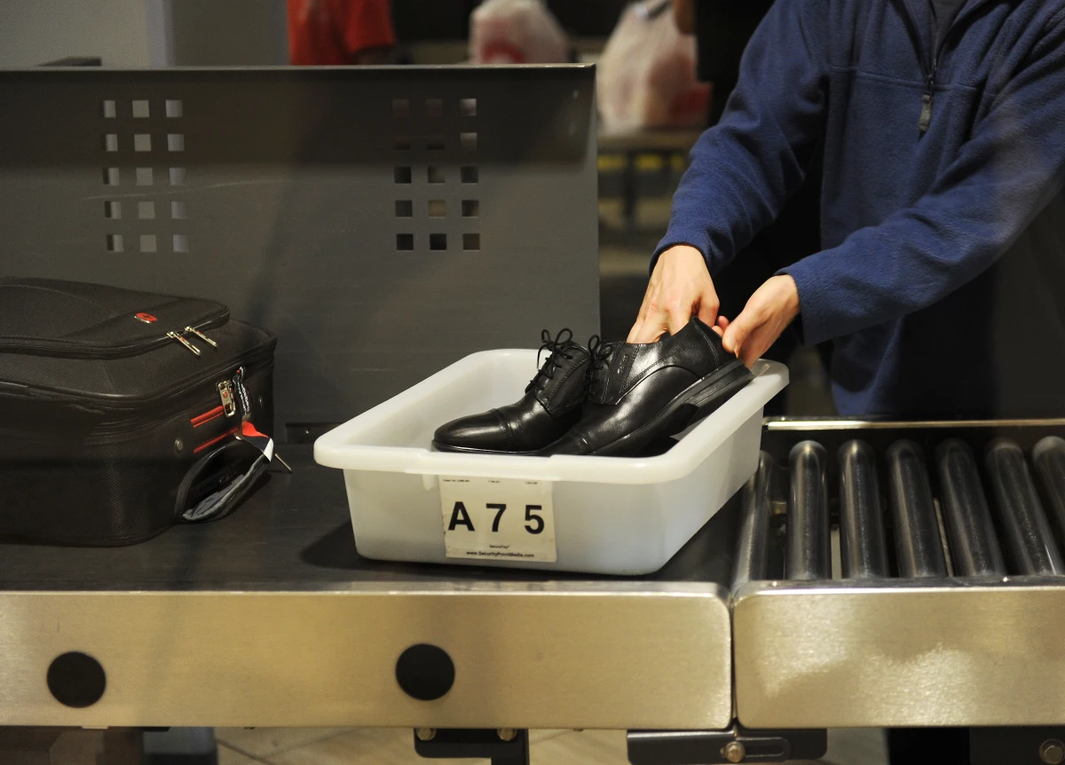 An air traveler puts his shoes in a bin before passing through a Transportation Security Administration (TSA) security checkpoint at Los Angeles International Airport in 2014.