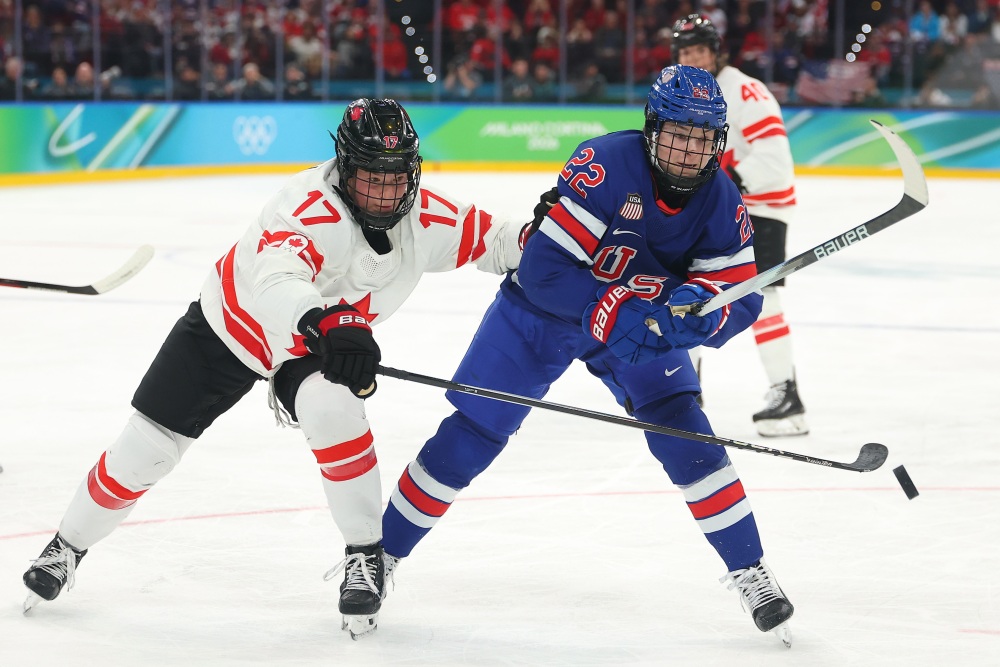 Ella Shelton of Canada (L) and Tessa Janecke (R) of the United States skate after the puck in the second period during the women's gold medal game at the 2026 Winter Olympics on Thursday in Milan, Italy. The U.S. defeated Canada 2-1 in overtime to claim the gold medal. (Getty Images)