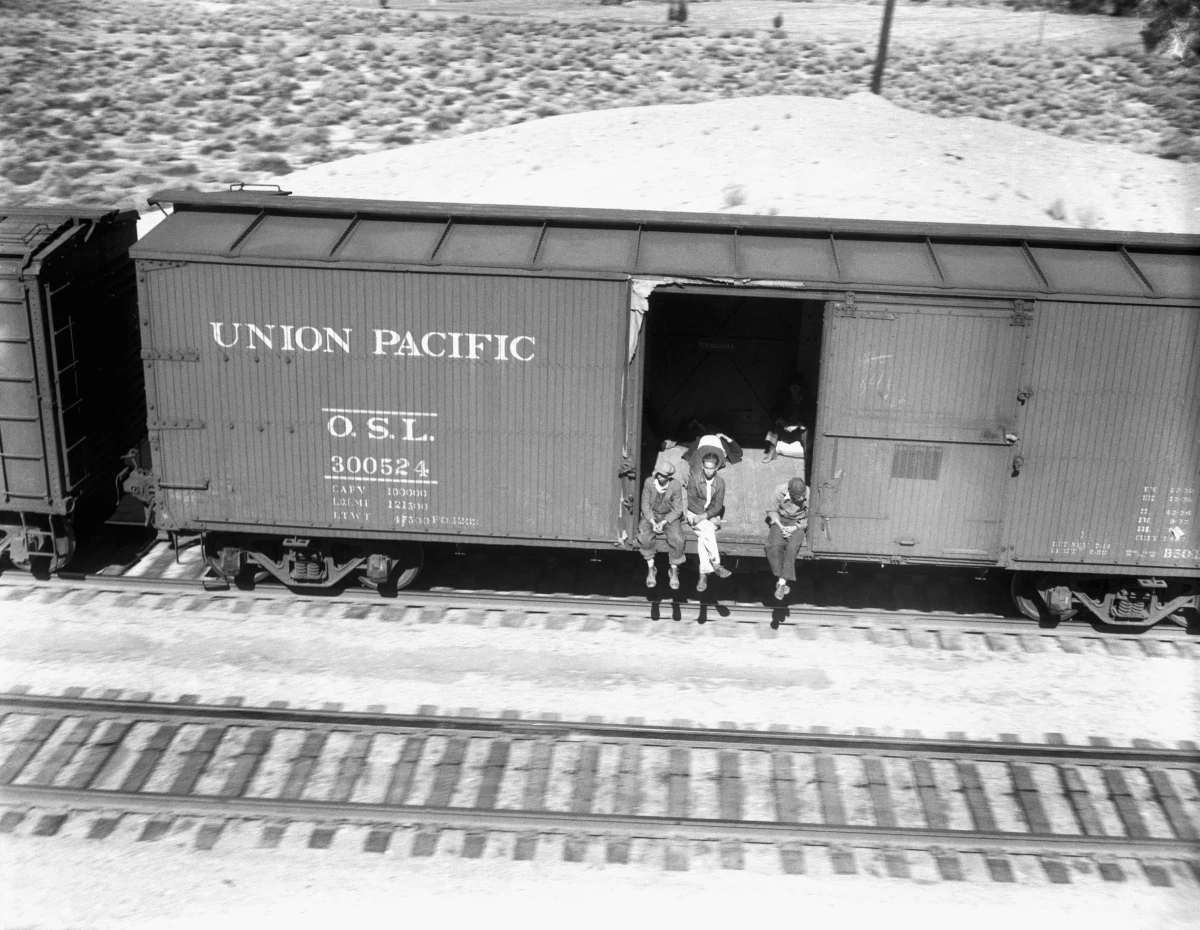 Hobos ride a freight car to Southern California in 1934.