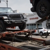 Jeeps are delivered to a dealership in Chicago on June 20, 2024. Stellantis, the parent company of Jeep, reported disappointing earnings for the first half of 2024.