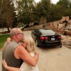 Allen Sather and his wife Kimberley embrace at the duplex they rent on W. Indian Trail Rd. after it burned in a wildfire in Spokane, Wash., Sunday, Aug. 2, 2026.