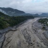 A drone view shows a major section of Pasang Lhamu Highway washed away along the swollen Trishuli River by recent flash floods.