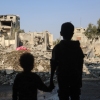 Children stare at the destruction following an Israeli strike in the Nuseirat refugee camp in the central Gaza Strip on Thursday.