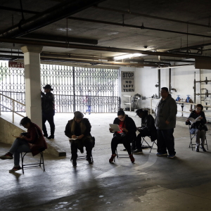 Hospitality workers wait in line to apply for unemployment benefits at the outset of the COVID-19 pandemic in March 2020.