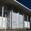 A tarp covers the facade of the John F. Kennedy Memorial Center for the Performing Arts in Washington, DC, on June 13. A federal judge has asked the arts complex's leadership to explain the purpose of the tarp and the surrounding scaffolding.