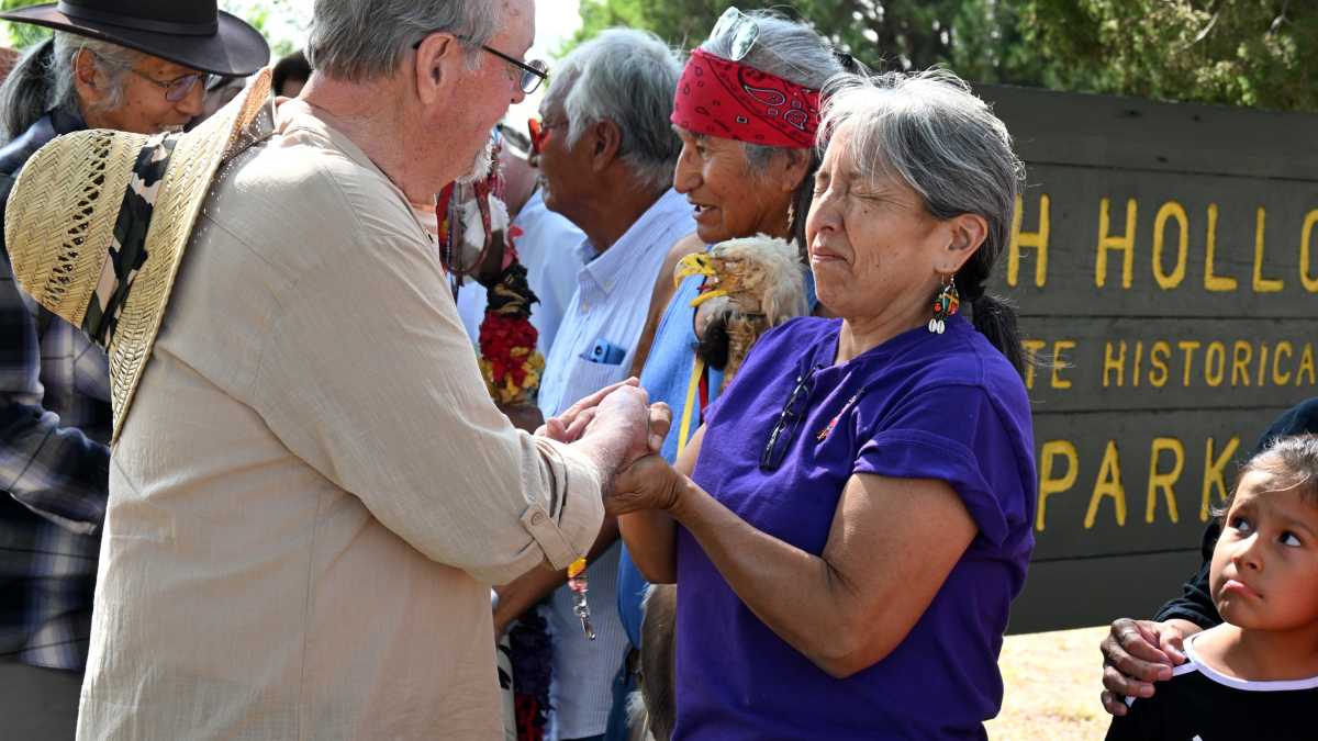 Karen Little Thunder and her cousin Phil Little Thunder greet attendees of a memorial ceremony in Nebraska's Ash Hollow State Historical Park Sept. 6.