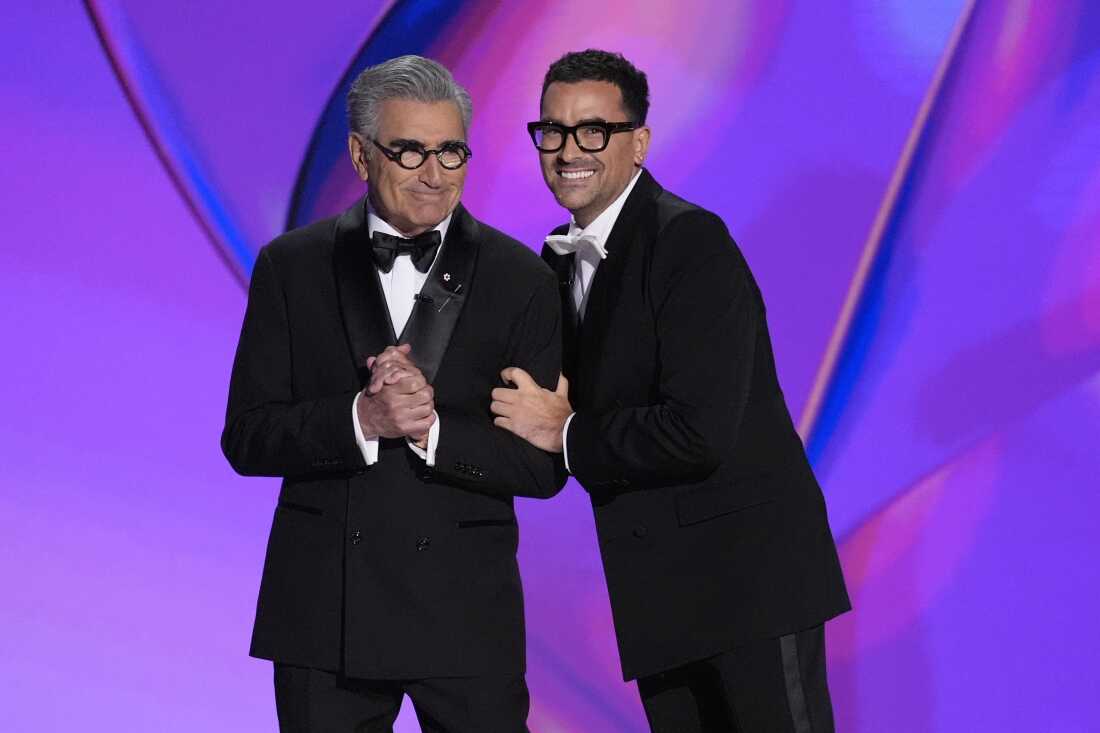 Hosts Eugene Levy and Dan Levy speak during the 76th Primetime Emmy Awards on Sunday at the Peacock Theater in Los Angeles.