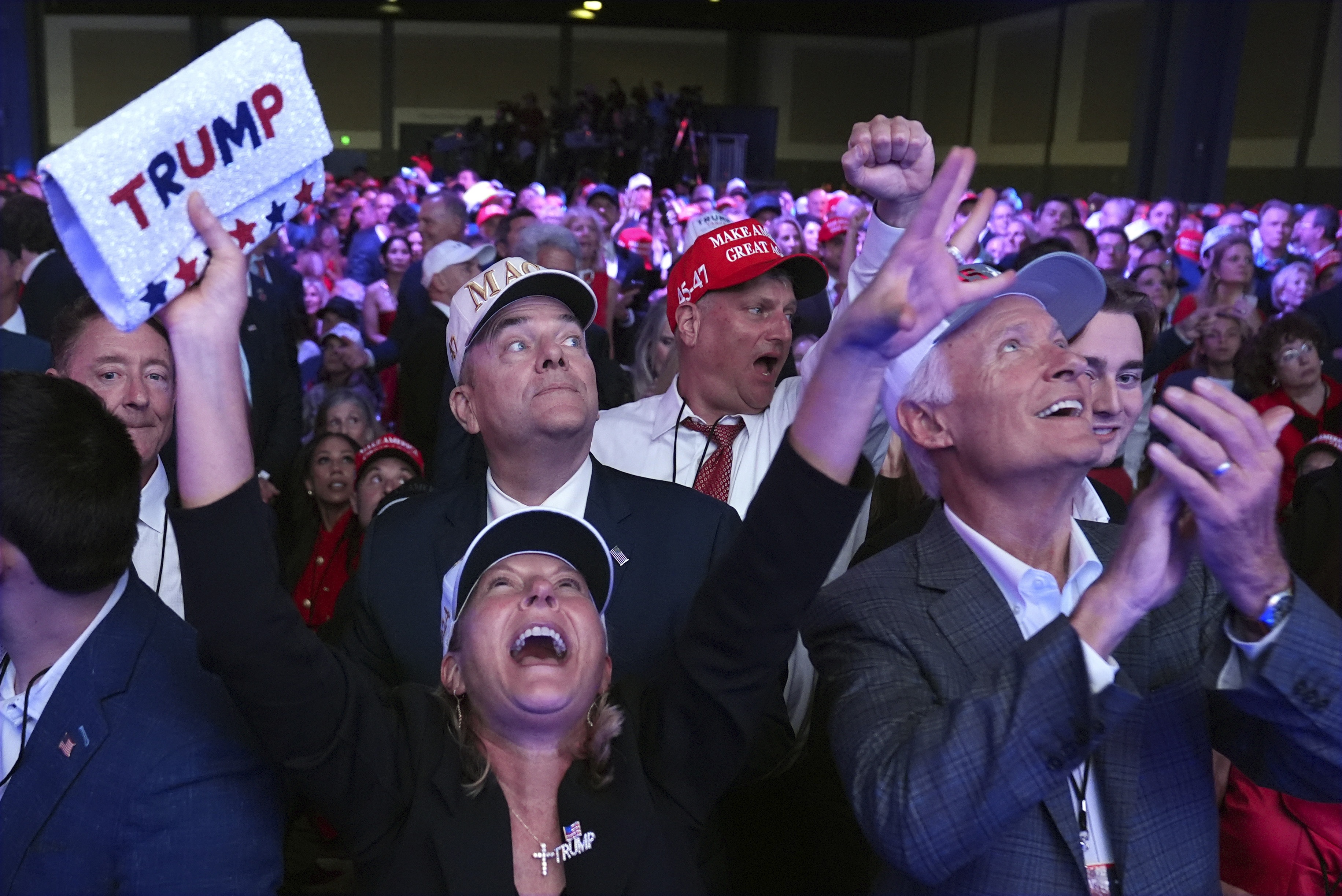 Supporters watch returns at a campaign election night watch party for Republican presidential nominee former President Donald Trump at the Palm Beach Convention Center. (AP)