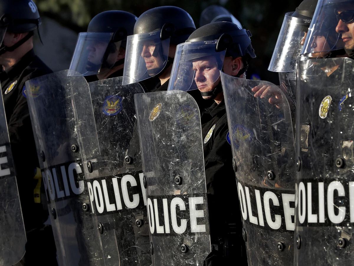 Phoenix Police officers watch protesters rally on June 2, 2020, during demonstrations over the death of George Floyd.