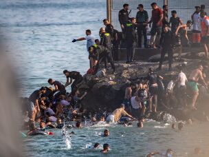 Migrants try to cross from Morocco into the Spanish enclave of Ceuta, Thursday, July 30, 2026.