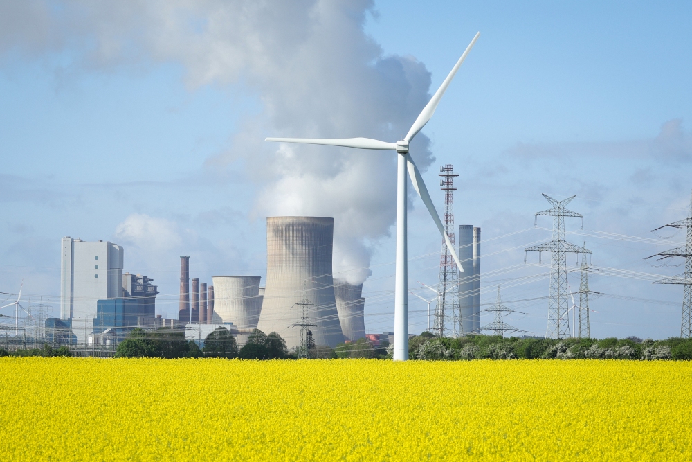Wind turbines stand next to the Neurath coal-fired power plant on April 15, 2024, in Ingendorf, Germany. (Getty Images)