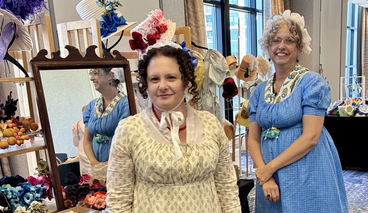 Milliner Dannielle Perry (right) and her assistant Mia Berg of Timely Tresses in their Regency-era togs.